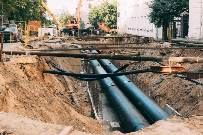 A marked utility line on site with a vacuum excavation truck positioned nearby, showing detection and excavation working as one sequence.